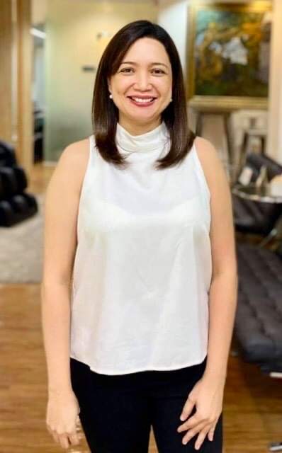 Coach Chelie smiling in a white top
